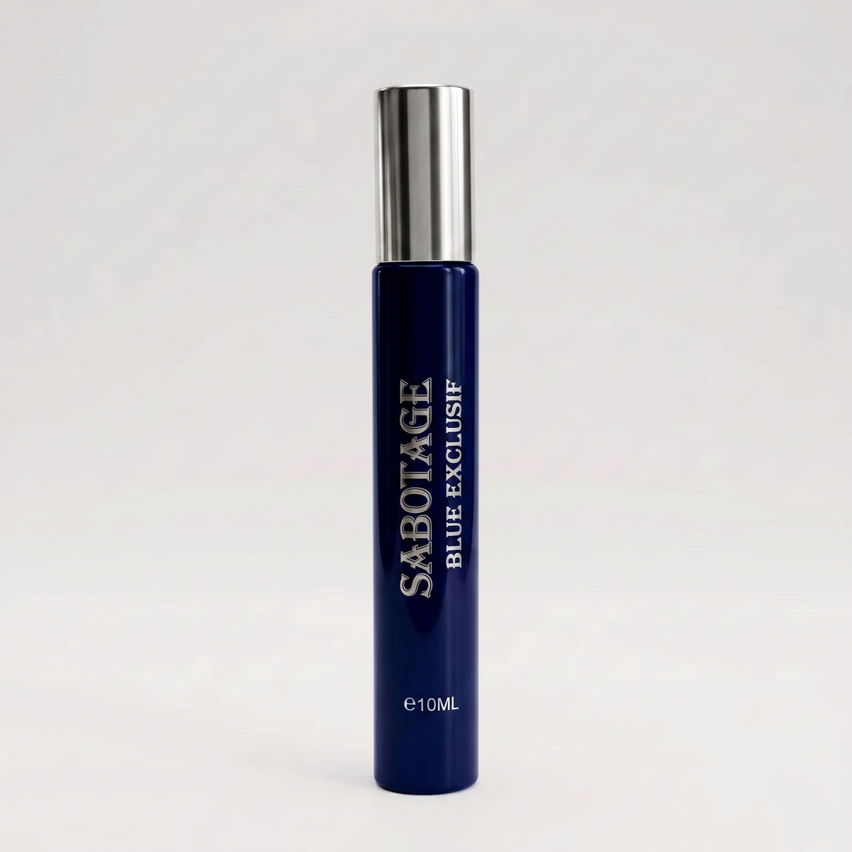 Sabotage Blue Exclusif 10ml travel spray bottle with deep navy blue glass and metallic silver cap against a light gray background