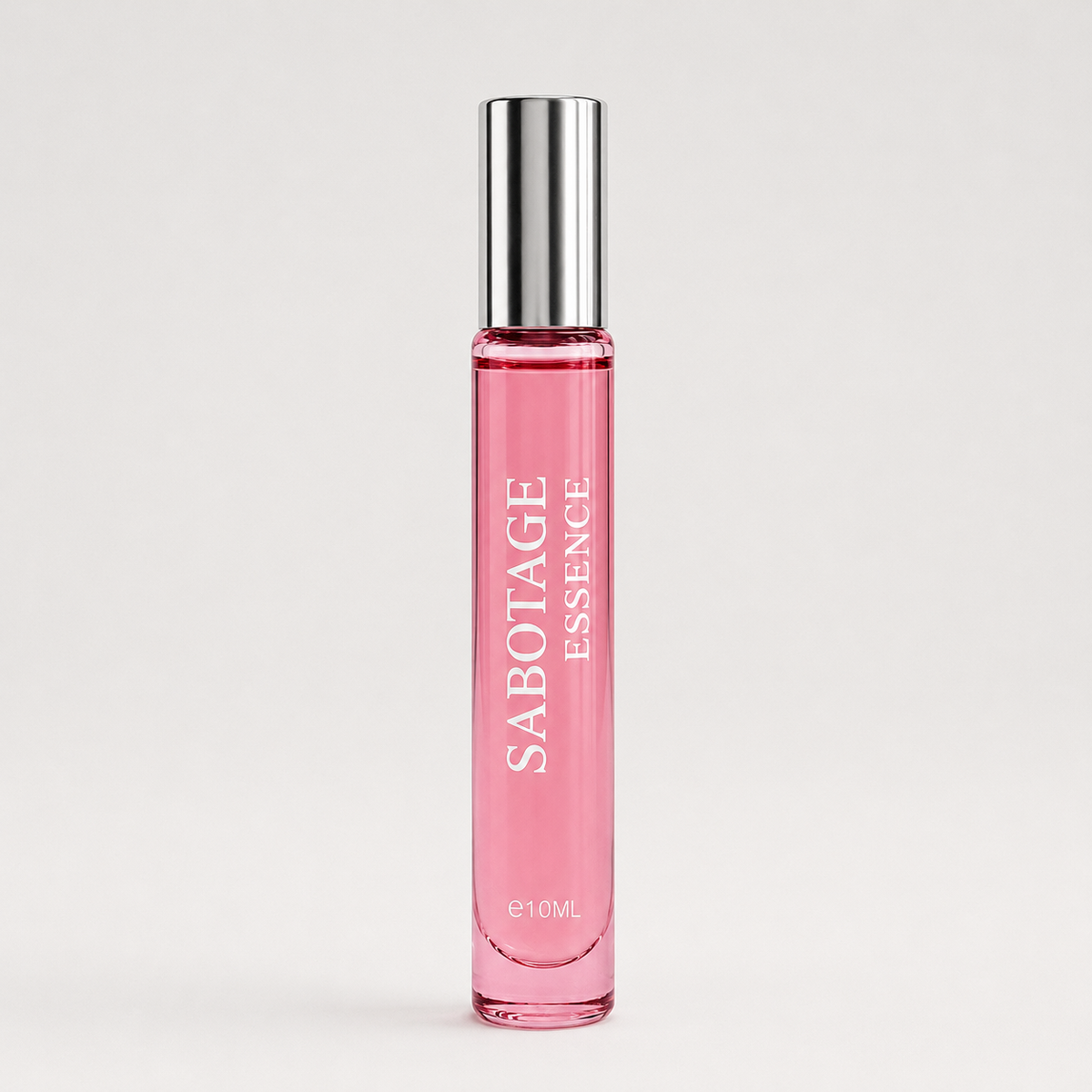 Sabotage Essence 10ml travel spray perfume bottle with clear glass, black cap, and vertical branding against a light background
