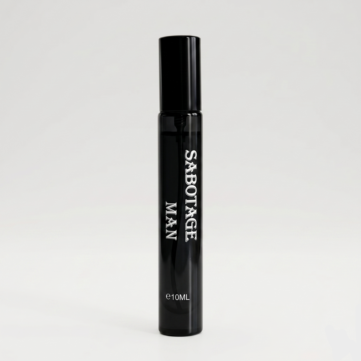Front view of Sabotage Man 10ml travel spray perfume bottle in sleek glossy black glass with white vertical lettering on a light gray background