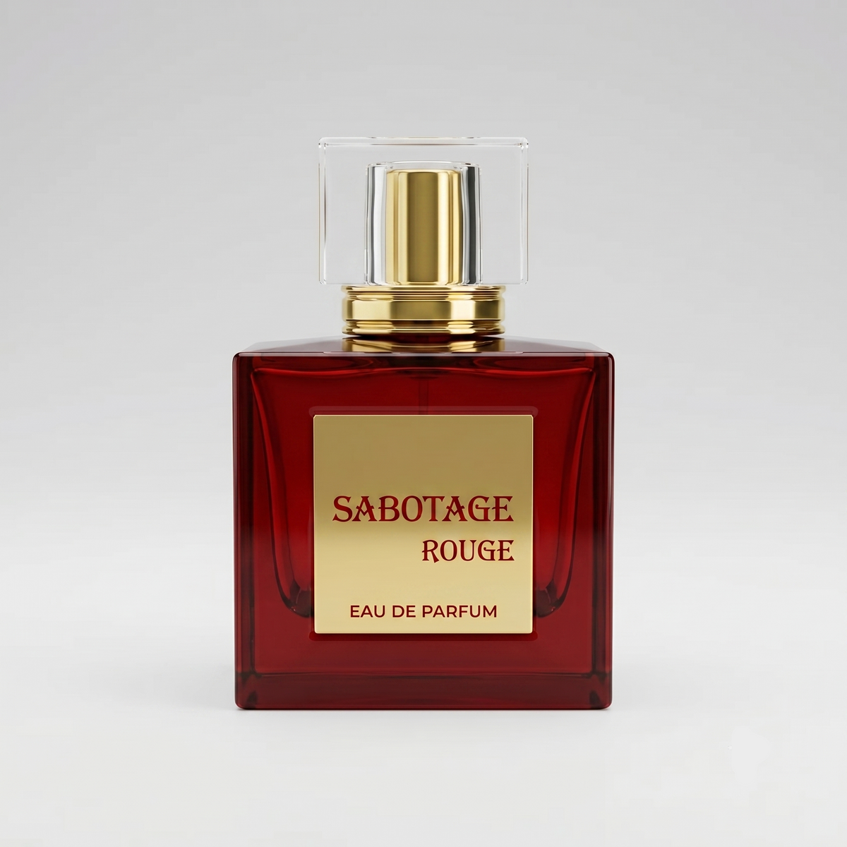 Front view of Sabotage Rouge 100ml Eau de Parfum in a square deep red glass bottle with gold label and clear rectangular cap against a light gray background