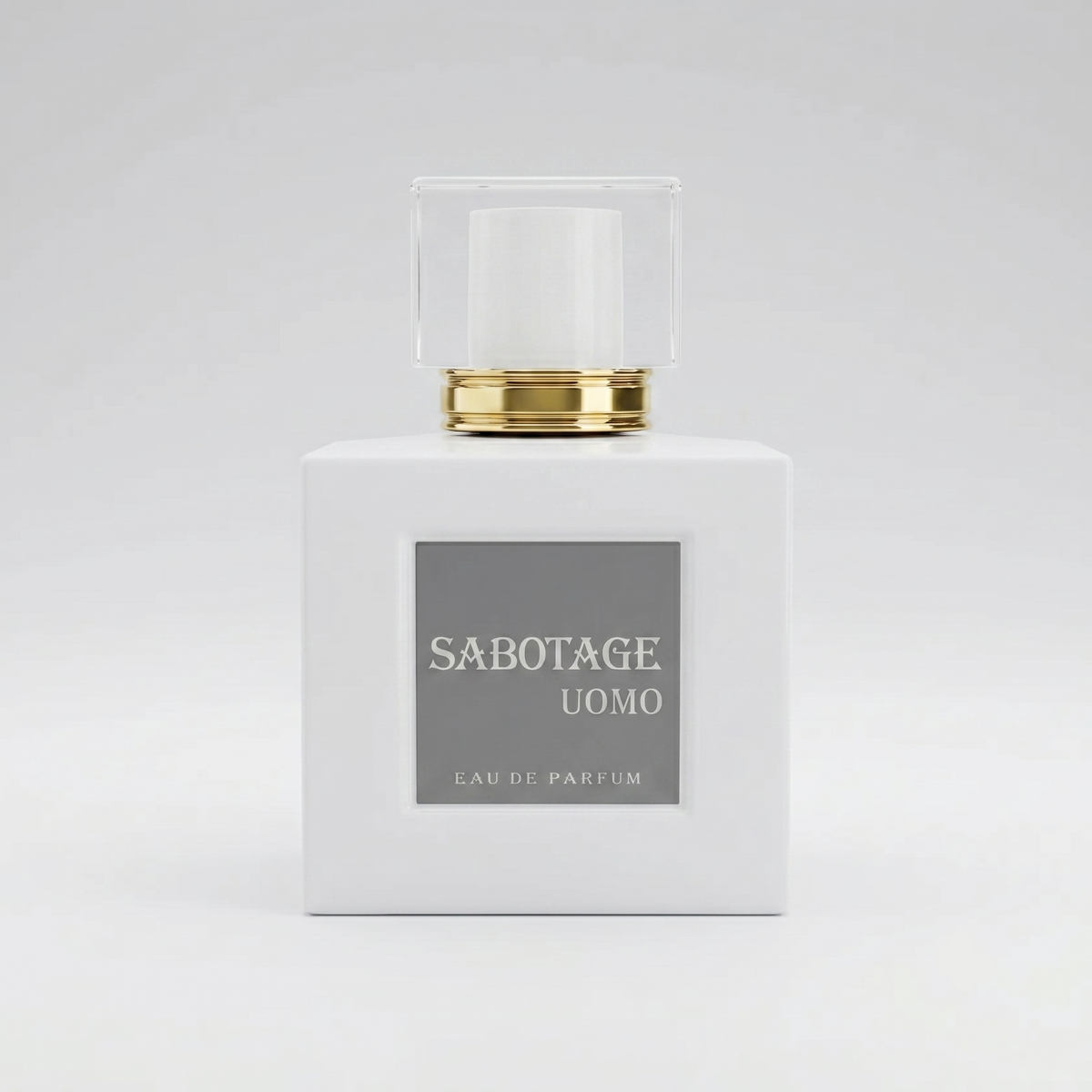 Front view of Sabotage Uomo 100ml Eau de Parfum in an opaque white square glass bottle with a gold collar, silver label, and clear cap against a light background